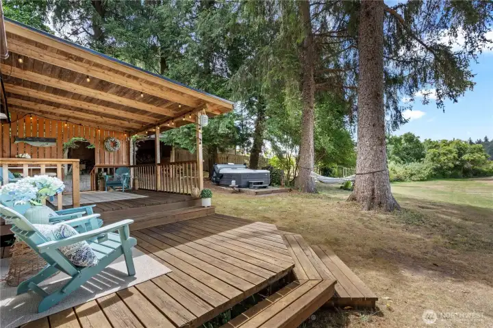 Enjoy outdoor dining and waterfront entertaining beneath the spacious covered deck. Enjoy outdoor dining and waterfront entertaining beneath the spacious covered deck.