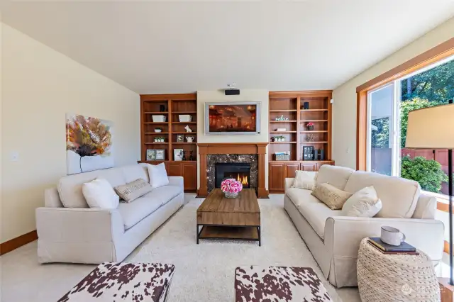 Family room with built-in shelves & cabinets, and gas fireplace.