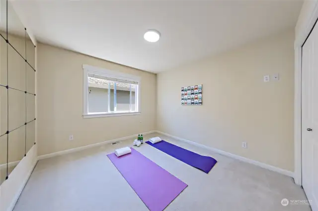 Bedroom #3 on upper level - staged as yoga room here.