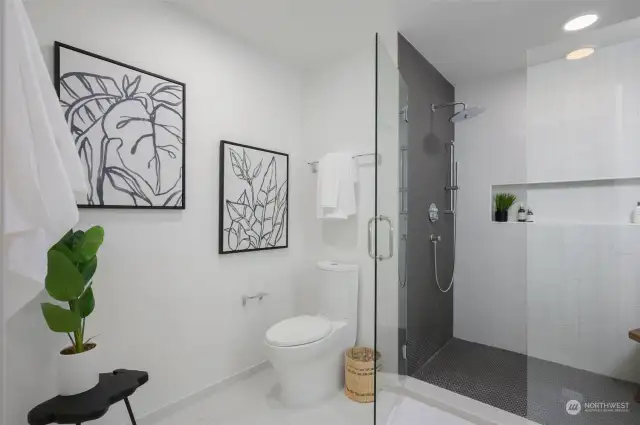 Bathroom features a ceramic tile walk-in shower and a floating quartz vanity with a daylight mirror.