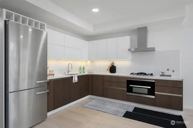 High-End Modern Kitchen with Miele Appliances, Custom Wine Built-In and Ample Countertop Space.