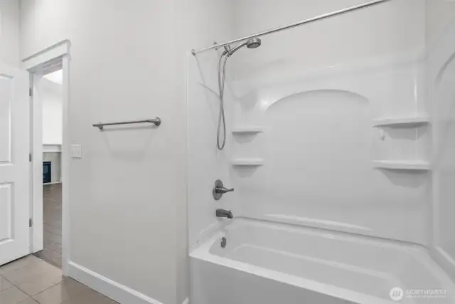 Located just off the second bedroom, this beautifully appointed full bathroom offers both elegance and function. It features bathtub, perfect for unwinding at the end of the day. A sleek vanity with ample storage, polished hardware, and a large mirror adds a refined touch, while modern lighting and tasteful fixtures complete the space. Whether for guests or daily use, this bathroom delivers comfort with a timeless aesthetic