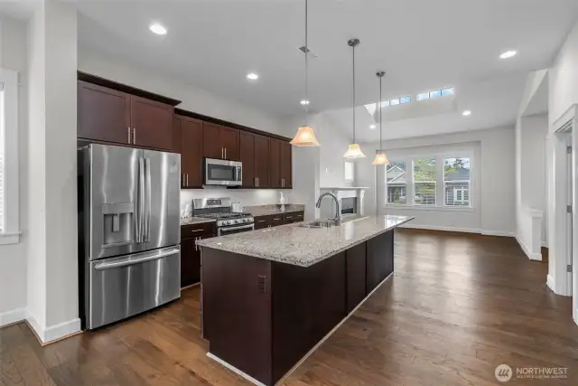 An entertainer’s dream, this stunning kitchen showcases gleaming hardwood floors and a spacious center island that invites gathering and conversation. Thoughtfully designed with abundant counter and cabinet space, it features custom soft-close cabinetry enhanced by elegant under-cabinet lighting. Stainless steel appliances provide both style and function, while a generous walk-in pantry and a dedicated buffet area—perfectly positioned between the dining and family rooms—ensure effortless entertaining and everyday convenience.