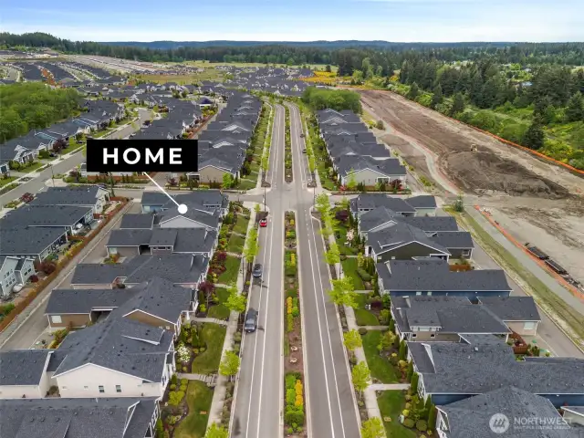 The aerial view showcases the home’s position within a beautifully designed neighborhood featuring tree-lined streets, landscaped sidewalks, and easy access to walking trails and parks. This exceptional location offers not only comfort and convenience but also a strong sense of community and lifestyle.