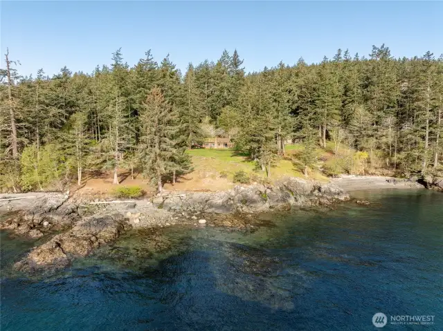 Stunning waterfront acreage with over 800 feet of shoreline, vintage cabin and cove beach.