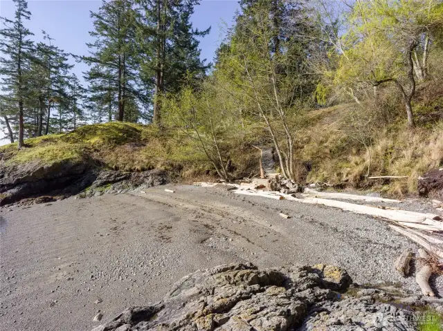 Gently sloping path from the yard leads right down the expansive cove beach.