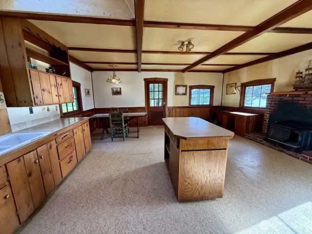 Cozy, vintage cabin with kitchen, dining and living room space.