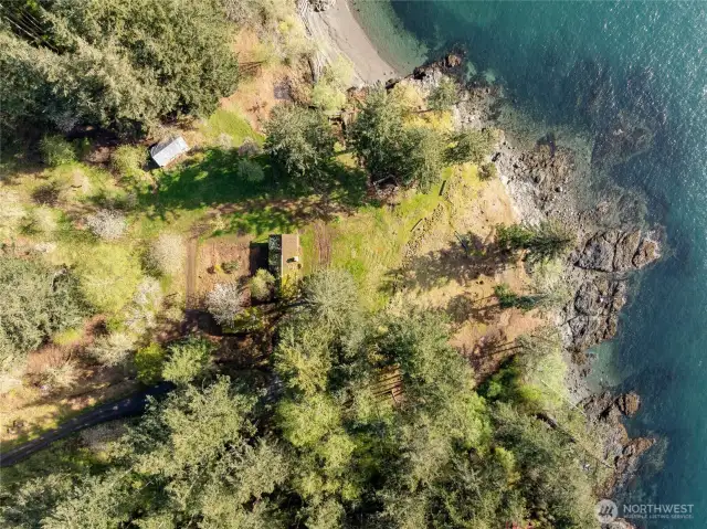 Aerial view with water frontage, cove beach, cabin and the outbuilding affectionately known by the family as  "the hideaway".