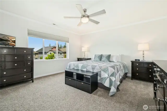 Primary suite bedroom with ceiling fan.