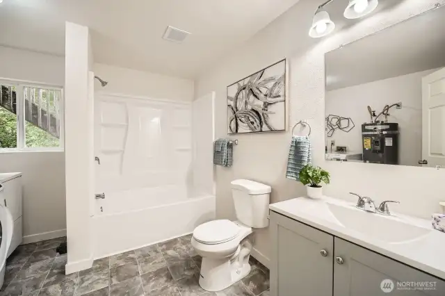 This bathroom is also home to the utility room.