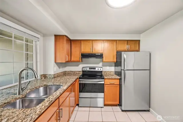 Spacious kitchen with full sized, in unit laundry to right of frame.