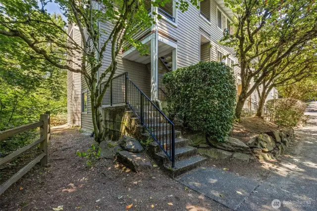 View from private street to end unit along creek. This unit is up these stirs on the second floor.
