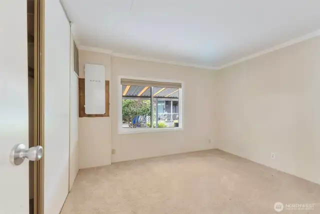 Further down the hall is the guest bedroom with closet. This room houses the newer electrical panel.