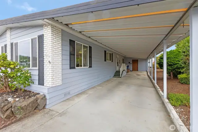 A carport to keep you dry to the back door complete with new electric vehicle charger.