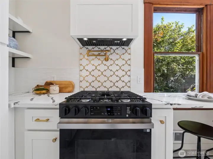 Gas range with gold pot filler and motion activated fan.