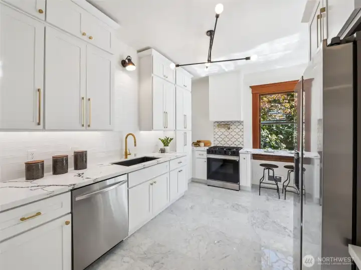 New kitchen and appliances, quartz countertops, marble floors.