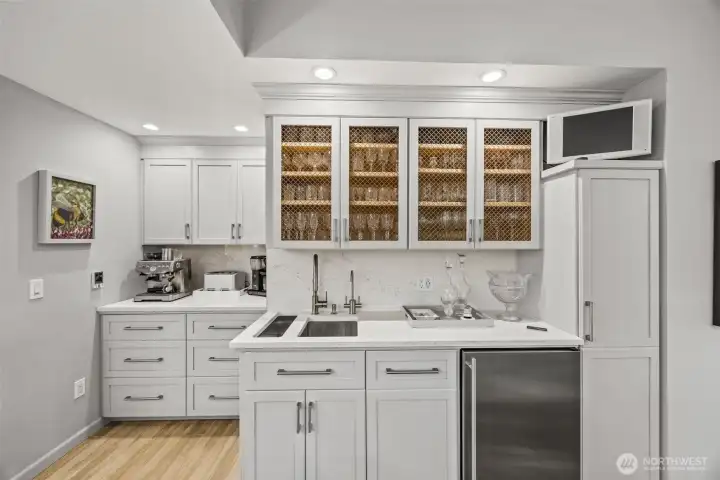 Awesome side wet bar and coffee station with under counter GE Monogram refrigerator with icemaker.