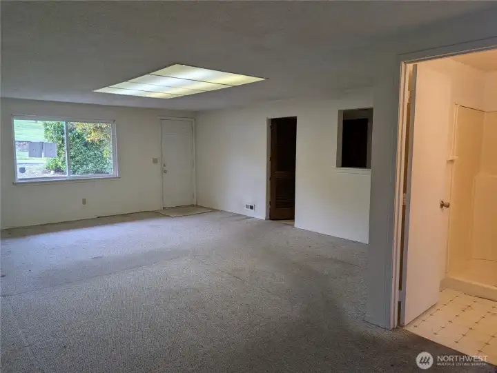 Large Rec room. This has been used as a primary or 4th bedroom with the 3/4 bath attached. #2111 5th St SW, Puyllup, WA 98371