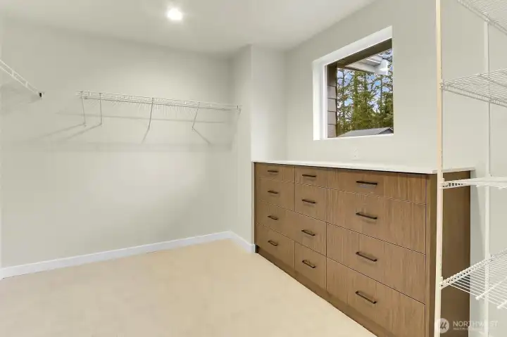 The walk-in closet features built-in storage for added luxury.