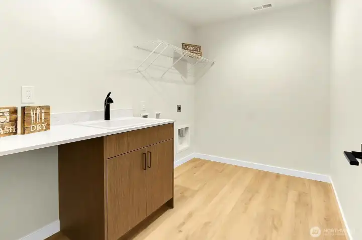 Upper level laundry room with sink provides ample space for that one chore we all love!