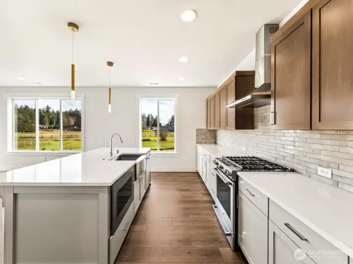 Full height tile back splash, farmhouse sink, gas range/oven, and gorgeous views!