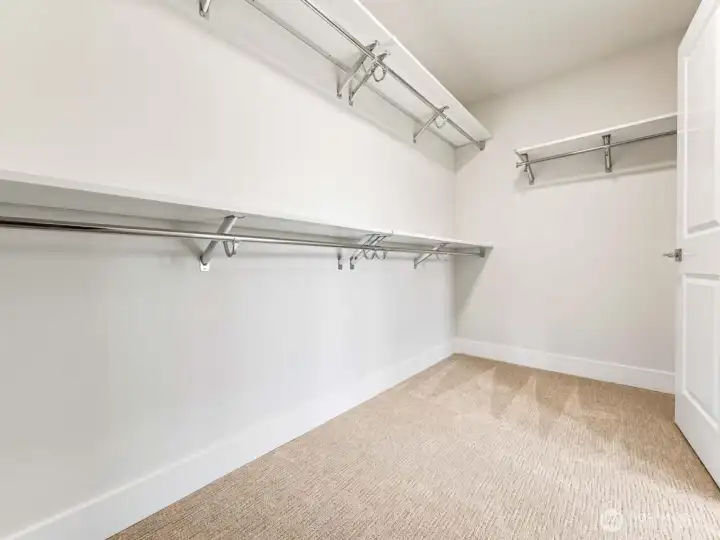 One of two primary walk in closets