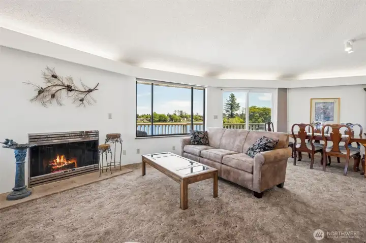 Main floor living room with a cozy fireplace and up-lighting.