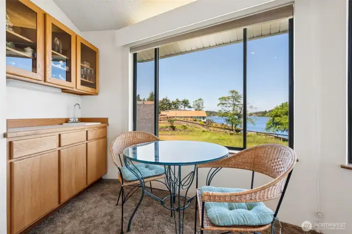 Wet-bar with sink, glass front cabinets and lake views.