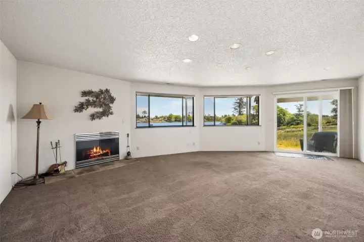 The ground level living room with lake views and it's own fireplace makes this level the perfect opportunity for multi-generational living.
