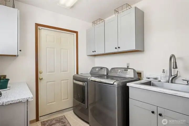 Spacious utility room with garage access.