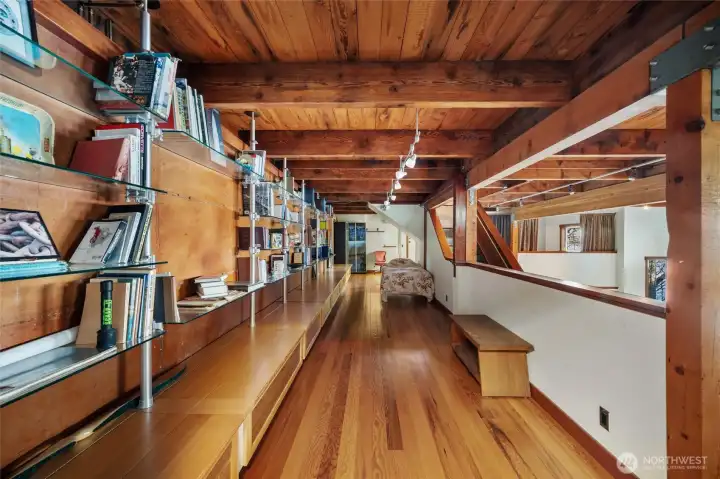 The library is the hallway between the rec room and the bedroom.
