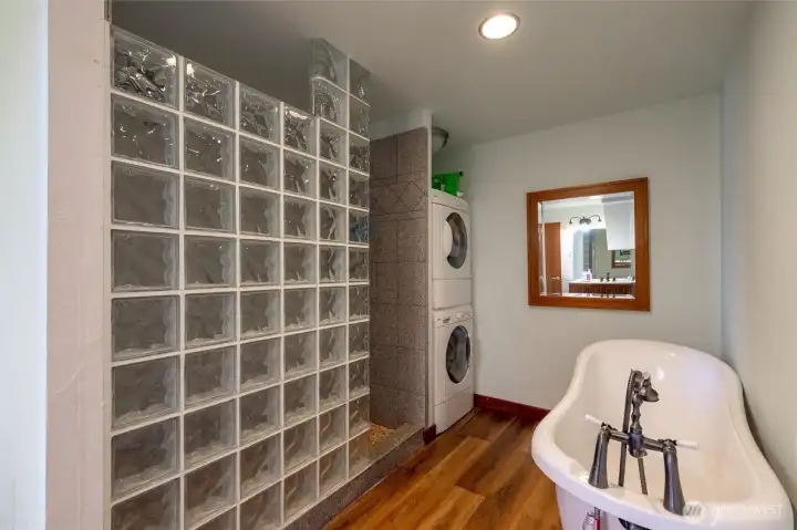 The full bath on the lower level has another full-size washer and dryer, as well as a separate shower and stunning soaking tub.