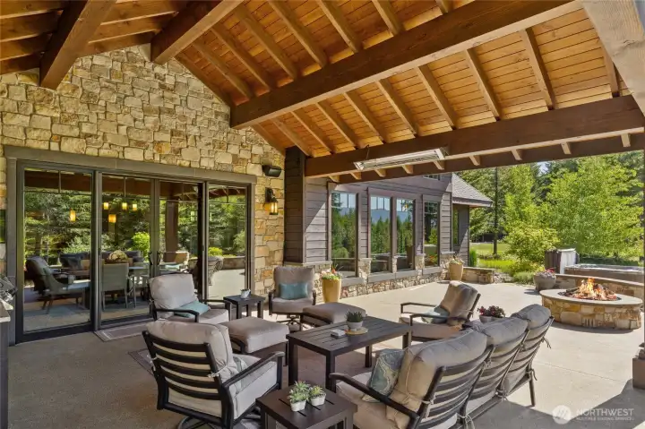 Stone wall and heat lamps with a fire pit