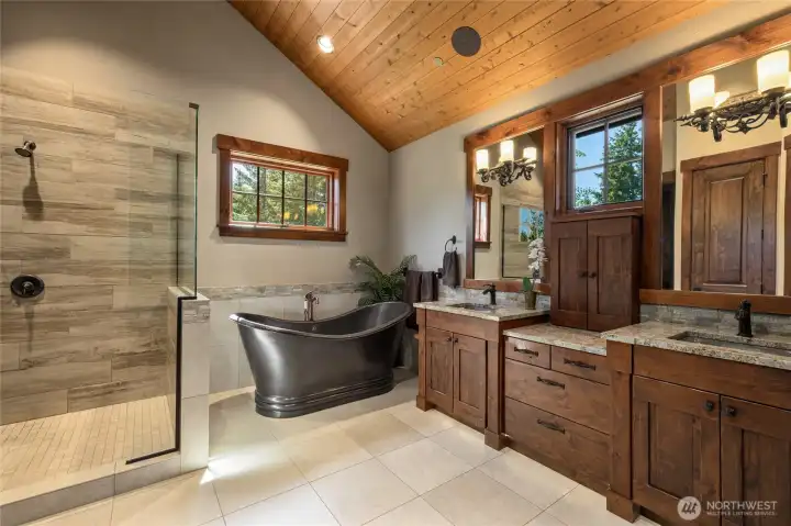Primary bathroom with heated floors, coper tub, and dual sinks