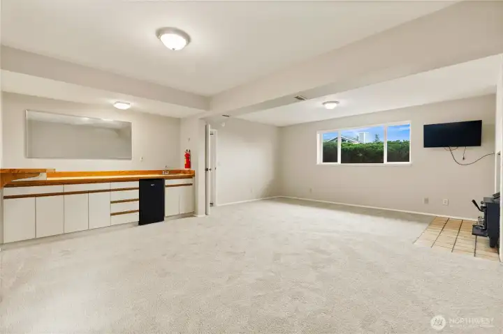 Wet bar includes small refrigerator and can be exited outside to large deck and play area
