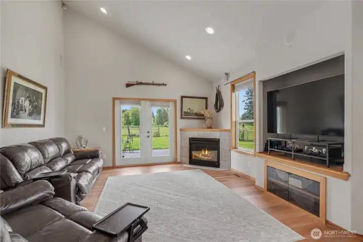Family room view, love patio doors leading to one of your expansive patios, the propane fireplace and tremendous cathedral ceilings!