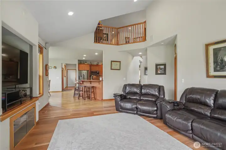 View from your family room to your kitchen, great for entertaining and watching the game. Plus the open staircase above really brings everything together. First floor Primary suite to your right.