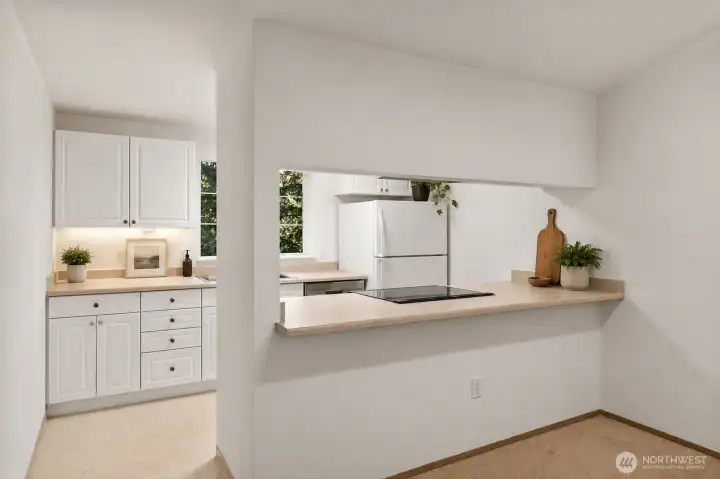 Functional kitchen with breakfast bar and generous cabinetry.  [Virtually staged]