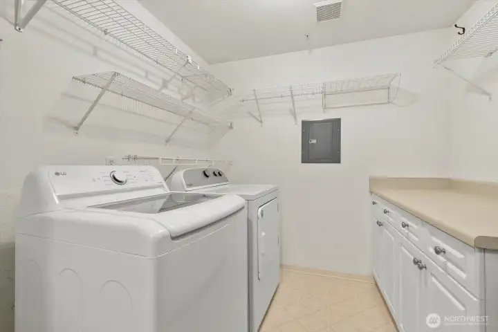 Exceptionally large utility room adds everyday convenience. Extensive counters and cabinetry keep essentials organized.  New full-size washer and dryer included.