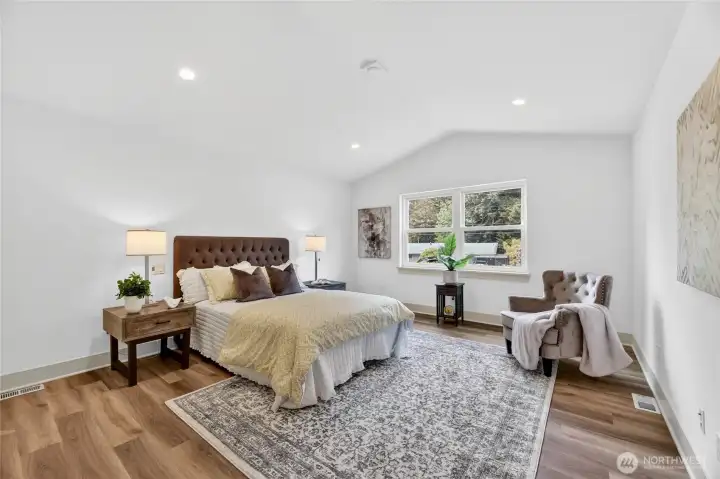 The first primary bedroom boasts vaulted ceilings
