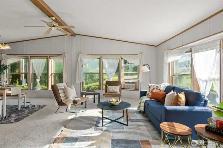 The vaulted ceilings and big windows make the living area bright, open, and easy to settle into.