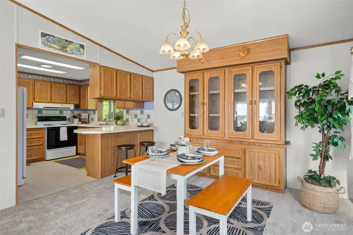 The built-in china cabinet is such a sweet bonus here, and there's still plenty or room for a good-sized dining table. And with the breakfast bar right nearby, there's another handy option for everyday meals, coffee, and conversation.