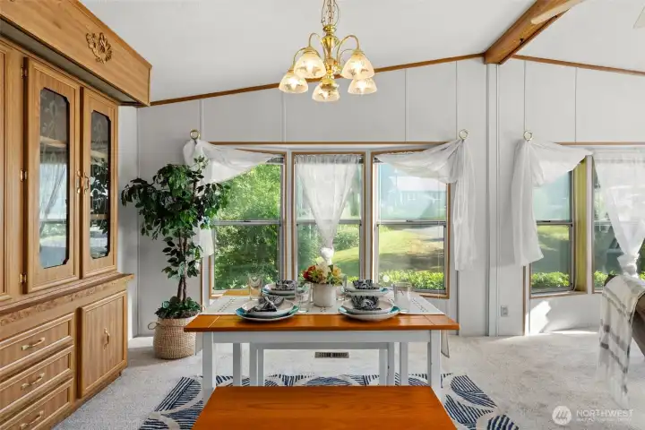 A lovely spot for everyday meals, with windows that look out toward the greenery beyond.