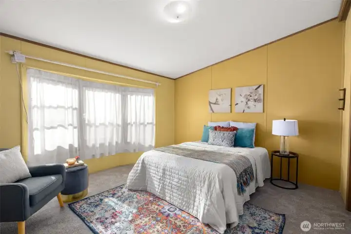 The vaulted ceilings continue into the primary bedroom, where east-facing windows bring in that soft morning light. Such a sweet way to start the day.