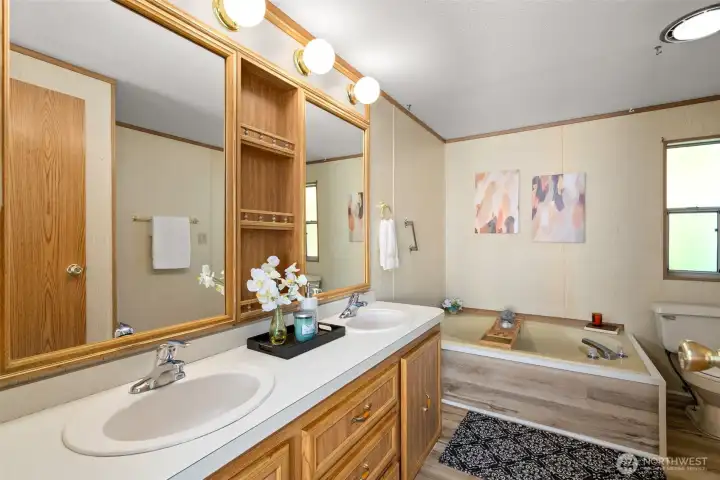 Yes, please and thank you, to a five-piece primary ensuite! Dual sinks, a soaking tub, separate shower, and brand-new LVP flooring make this bathroom simply amazing.