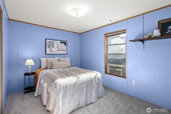 The second bedroom is nicely sized, and the window A/C unit is a great bonus for warmer days. There’s another unit in the front room too, keeping the main living area comfortable when summer shows up.