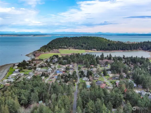 Aerial view of the North beach neighborhood, Chinese garden, Fort Worden, the Strait, Port Townsend bay, Whidbey, Indian & Marrowstone islands and the Cascade Mountain range.