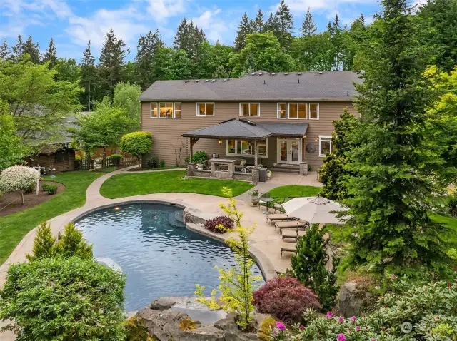 This backyard is primed for entertainment! Featuring a custom pool with depths ranging from 4 feet at the shallow end to 8 feet at the deep end, and a darkly painted bottom for an enhanced aesthetic appeal.
