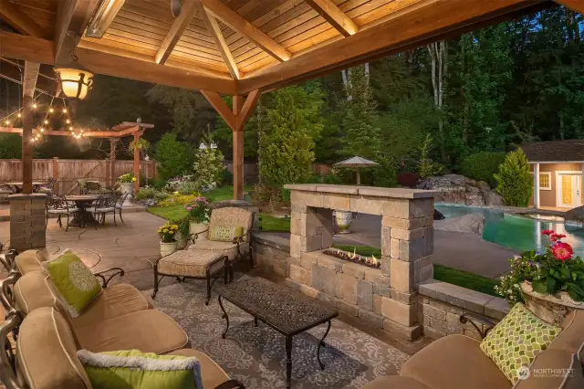 A cozy, covered outdoor living space that offers heaters and a gas fire place. A great space for any time of the year!