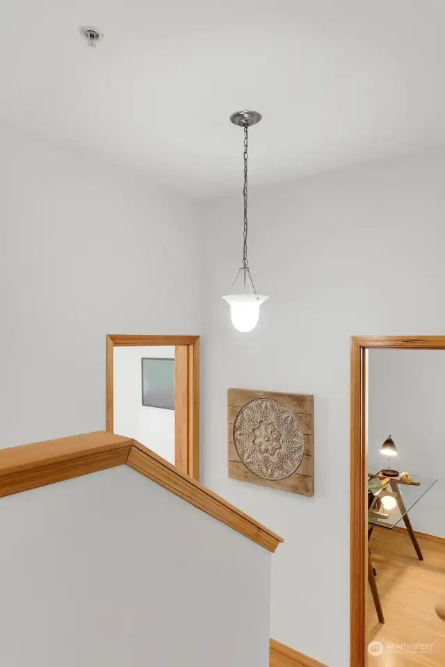 Vaulted ceilings and half walls, create light in stairwell and unite all three levels